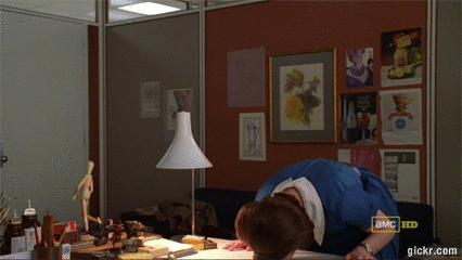 Peggy from Mad Men banging her head on the desk gif