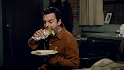 Man eating salad wrap gif