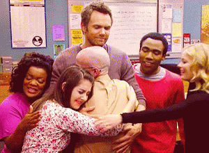 Gif from Community TV show of the group hugging and smiling  (who am I)