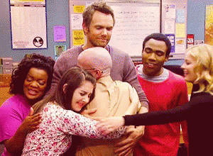 Gif from Community TV show of the group hugging and smiling (who am I)