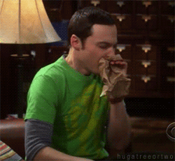 Sheldon Cooper blowing into a paper bag gif