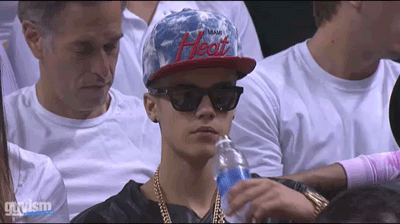 Justin Bieber drinking water from a bottle and taking sips gif