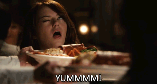 Girl holding a plate of food up to her nose and saying yummmm! gif