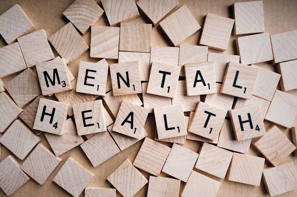 scattered blocks with mental health spelled out in scrabble tiles on top