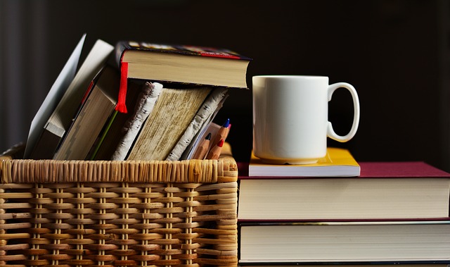 self-care suggestion pile of books and mug