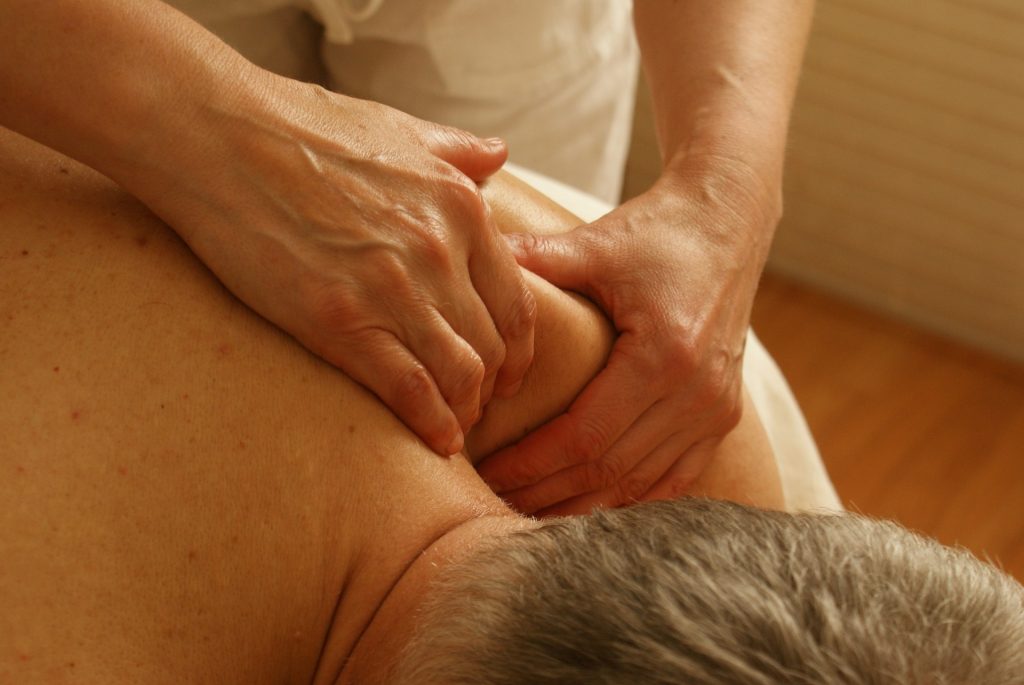 Man having sports massage on his left shoulder