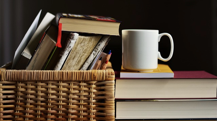 What Exactly Is Self-Care - Pile of book and a coffee cup