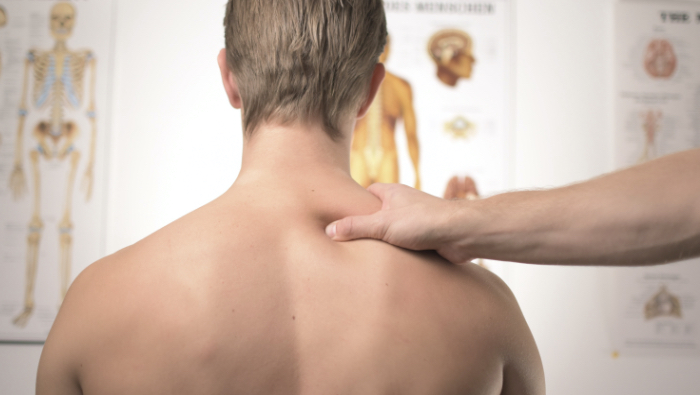 Massage for Shoulder Pain - Practitioner with hand on client's shoulder