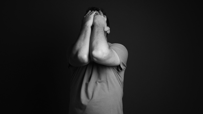 Anxiety or Excitement - man clutching his face with his hands