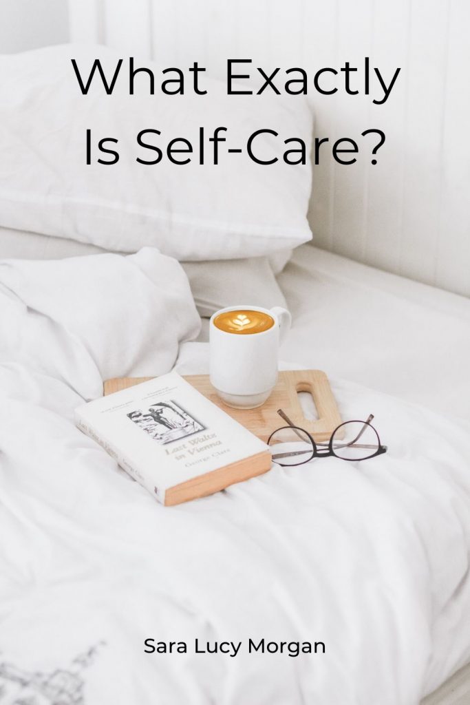 What exactly is self-care - bed with book and a cup of coffee along with reading glasses