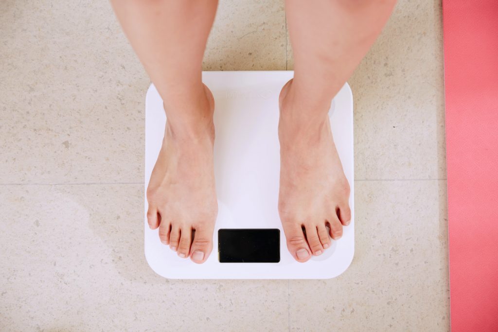 How To Accept My Body - image of feet on weighing scales.